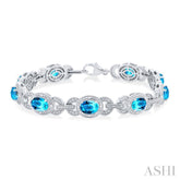 7x5 MM Oval Shape Blue Topaz and 1/10 Ctw Round Cut Diamond Semi-Precious Bracelet in Sterling Silver