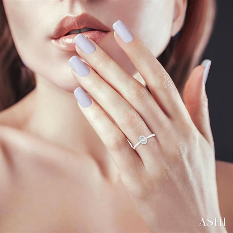 5x3 MM Oval Shape White Topaz and 1/20 Ctw Single Cut Diamond Halo Semi-Precious Ring in 10K White Gold