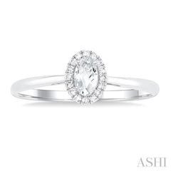 5x3 MM Oval Shape White Topaz and 1/20 Ctw Single Cut Diamond Halo Semi-Precious Ring in 14K White Gold
